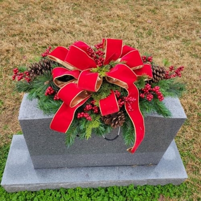 Product: Headstone Saddle with Red Berries, Pinecones, and Red Velvet Ribbon - Christmas Memorial Decoration - Artificial Grave Flowers