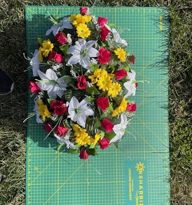 Product: Jucgghk Vivid and Realistic Floral Art Artificial Cemetery Flowers Saddle,White, Yellow and Red Single Headstone Cemetery Saddle for Outdoor Grave Decorations