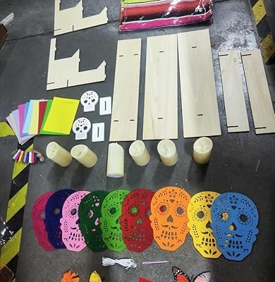 Product: SmoothNovelty 89 Pcs Day of The Dead Decorations 9 Mexican Papel Picado 1 Table Runner 50 Marigold Flower Heads 10 Butterflies 6 LED Candles 1 Display Stand 10 Paper Frames 2 Wood Skull Signs